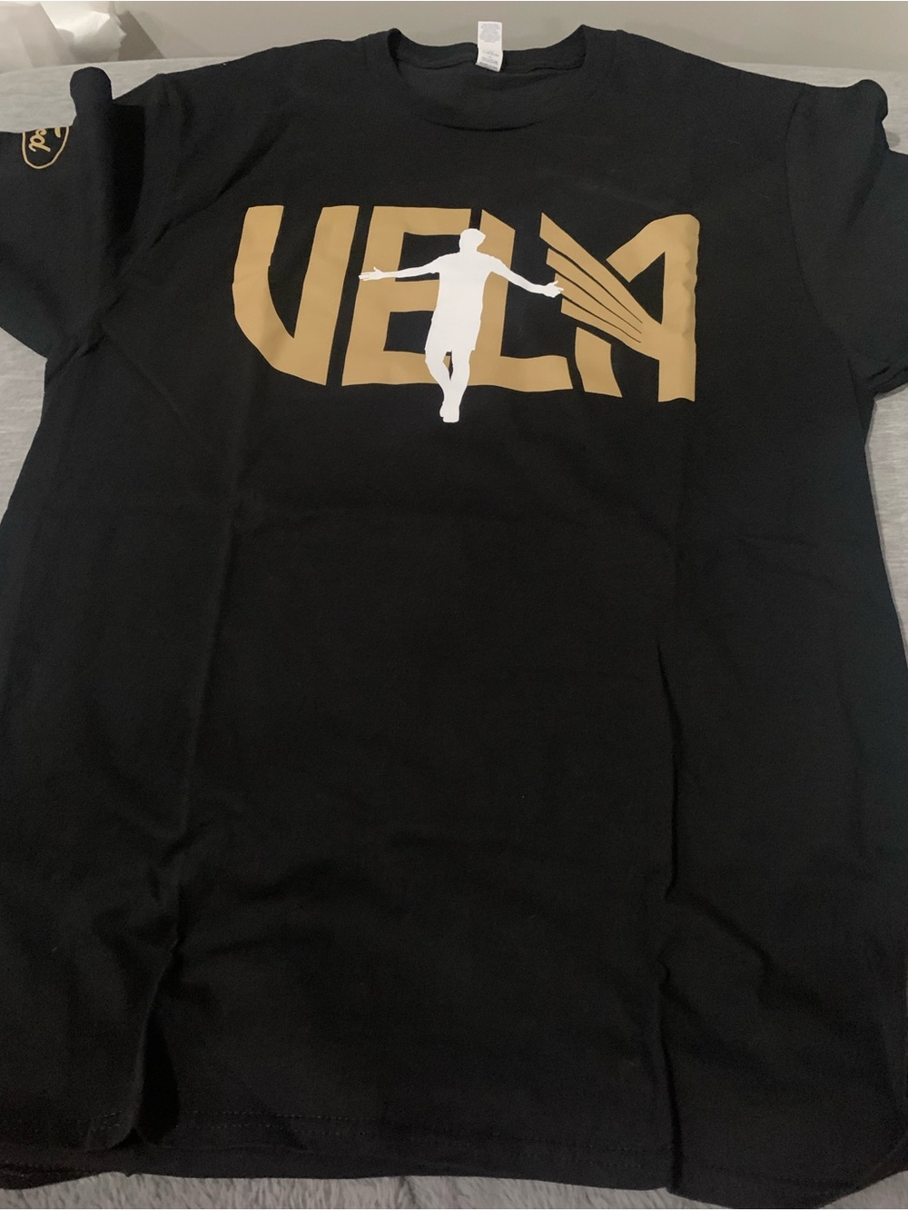 Vela Black Graphic Tee with Gold Logo